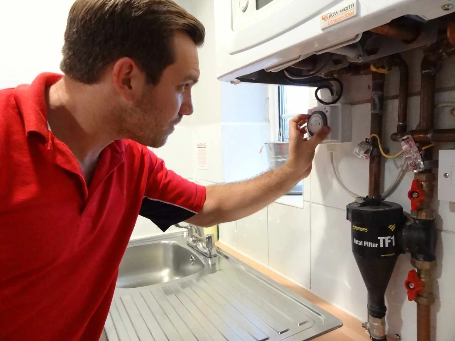 Weybridge Plumbers 247 boiler repair engineer working on a boiler in Weybridge