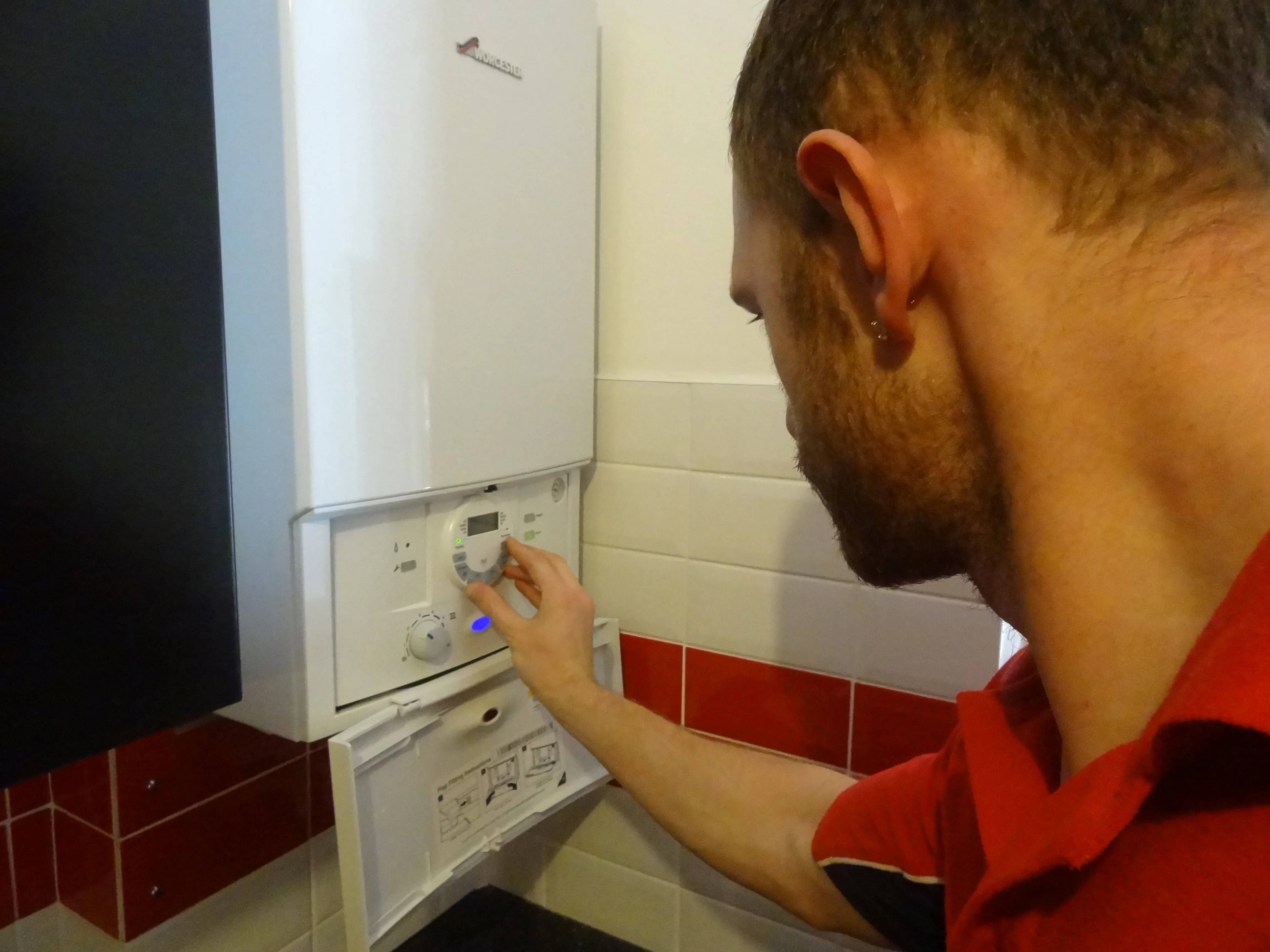 Weybridge Plumbers 247 engineer working on a boiler installation in Weybridge